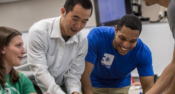 students working with professor